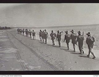 PONGANI, NEW GUINEA. 1942-11. MEMBERS OF 2/6TH AUSTRALIAN INDEPENDENT COMPANY CARRY OUT TOUGHENING-UP MARCHES ALONG THE COAST WHILE WAITING FOR ORDERS FROM HQ TASK FORCE AS TO THE COMPANY'S ROLE IN ..