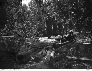 SOUTH BOUGAINVILLE ISLAND. 1945-01-24. A SMALL PATROL SETTING OUT FROM THE CAMP OF "D" COMPANY, 9TH INFANTRY BATTALION SOON AFTER THE UNIT TOOK OVER FROM "D" COMPANY, 42ND INFANTRY BATTALION. ..