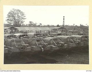 LAE, NEW GUINEA, 1944-03-26. AMPHIBIOUS DUKWS, (LANDING CRAFT MECHANIZED) AT THE 337TH UNITED STATES ORDNANCE DEPOT. THE MOTOR POOL AND ASSEMBLY LINE ARE IN THE BACKGROUND