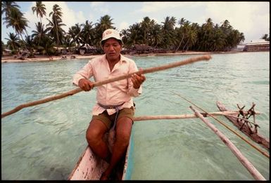 Man in outrigger canoe, Cook Islands