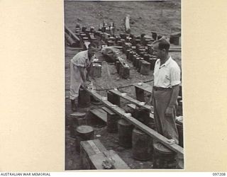 WEWAK POINT, NEW GUINEA. 1945-09-28. TROOPS STAKING THEIR CLAIMS ON SEATS THREE HOURS BEFORE THE COMMENCEMENT OF THE PERFORMANCE BY THE DARYA COLLIN BALLET TROUPE AT HEADQUARTERS 6 DIVISION BY ..