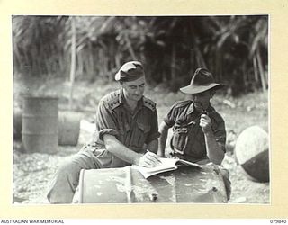 KALAI PLANTATION, NEW BRITAIN. 1945-03-15. OFFICERS OF AN ADVANCE PARTY OF THE 16TH INFANTRY BATTALION, 13TH INFANTRY BRIGADE, AWAIT THE ARRIVAL OF THEIR TROOPS. IDENTIFIED PERSONNEL ARE:- WX29788 ..