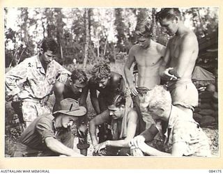 BOUGAINVILLE, SOLOMON ISLANDS. 1944-12-09. PRIVATE E.G. SMITH, 15 INFANTRY BRIGADE (1), DEMONSTRATING BREN GUN CHARACTERISTICS TO INTERESTED MEMBERS OF THE 182 INFANTRY REGIMENT, UNITED STATES ..