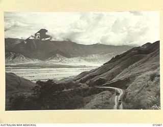 DUMPU, NEW GUINEA. 1944-04-20. RAMU VALLEY AND THE ROAD TO GUY'S POST VIEWED FROM THE LAKES AREA SITUATED NEAR HEADQUARTERS 15TH INFANTRY BRIGADE