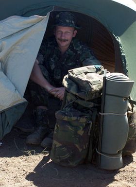 British Royal Marines Corporal Allum sits inside his tent during some down time at Pohakuloa Training Area on the Big Island of Hawaii