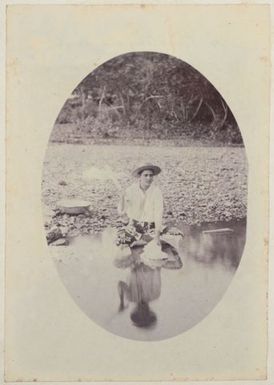 Woman washing clothes in a river. From the album: Cook Islands