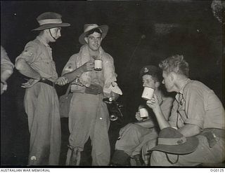 VIVIGANI, GOODENOUGH ISLAND, PAPUA. 1943-10-12. BEAUFORT AIRCREW OF NO. 8 SQUADRON RAAF WHO TOOK PART IN THE AIR ATTACK ON RABAUL. A DRINK OF HOT COCOA BEFORE DAWN SOOTHES TIRED BODIES AFTER A LONG ..