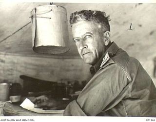 KILIGIA, NEW GUINEA, 1944-03-16. QX36344 BRIGADIER G.V. MORIARTY , MC, VD, COMMANDER, HEADQUARTERS, ROYAL AUSTRALIAN ARTILLERY, 5TH DIVISION, IN HIS OFFICE