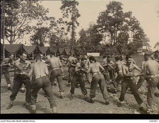 Lae, New Guinea. 1944-07-27. Members of 22 Platoon, F Company, 2/1st Guard Regiment, doing physical training exercises. Identified personnel are: Lance Corporal A. M. Hodges (1); Sergeant H. H. ..