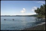 Children on canoes, playing on the beach