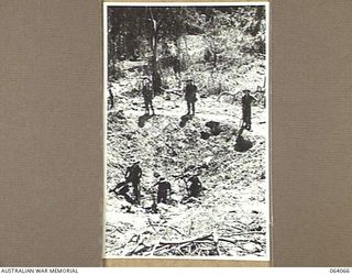 NAMBARIWA, NEW GUINEA. 1944-01-21. AUSTRALIAN INFANTRYMEN EXAMINING A LARGE CRATER WHICH WAS FORMED WHEN A STICK OF HEAVY BOMBS STRADDLED A JAPANESE DUMP IN THE SIO AREA