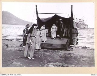 Four of five Catholic nuns coming ashore from a landing barge after they were released by the Japanese during a surrender ceremony at Fangalawa Bay. The nuns, Sisters M Brigitta, M Aquilina, M ..