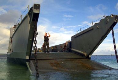 Beach MASTER 3 Brandon Schieber, Beach MASTER Unit 1, signals and coordinates the up loading of Landing Craft, Utility (LCU) 1634 in Inner Apra Harbor, Guam in support of Exercise TANDEM THRUST 2003