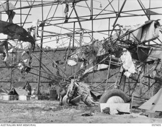 SALAMAUA AREA, NEW GUINEA. 1943-09-20. BOMBED AND BURNT OUT JAPANESE HANGAR AND AIRCRAFT IN THE 312TH AUSTRALIAN LIGHT AID DETACHMENT AREA