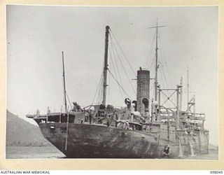 SIMPSON HARBOUR, RABAUL, NEW BRITAIN. 1945-10-13. THE JAPANESE TANKER 5301, (9,000) TONS) WHICH WAS RAISED FROM THE BOTTOM OF THE HARBOUR BY PERSONNEL OF COMMONWEALTH MARINE SALVAGE BOARD, WORKING ..