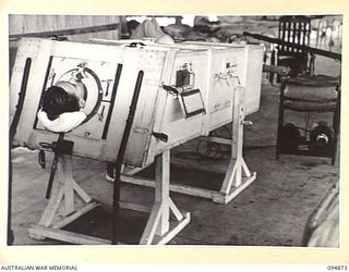 LAE AREA, NEW GUINEA. 1945-08-11. SERGEANT H.F. SMITH IN AN ARTIFICIAL RESUSCITATOR IN A SURGICAL WARD OF 2/7 GENERAL HOSPITAL