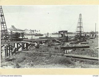 MADANG, NEW GUINEA. 1944-06-26. A LIBERTY SHIP WHARF BEING BUILT BY TROOPS OF THE 2/4TH FIELD SQUADRON