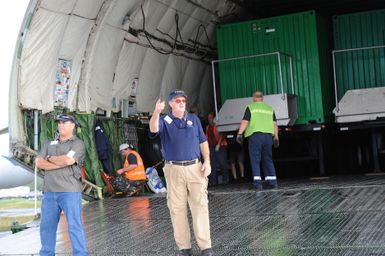 Earthquake ^ Flooding ^ Tsunami - Pago Pago, American Samoa, October 13, 2009 -- Mark Ackerman, Federal Emergency Management Agency Staging Area Manager, directs the unloading of generators from the Antonov AN-225 cargo plane. The cargo plane is the largest in the world and carried generators contracted by the Federal Emergency Management Agency to assist the island with electrical power restoration. David Gonzalez/FEMA