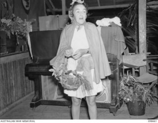 LAE, NEW GUINEA. 1945-11-08. LIEUTENANT COLONEL M.J. SPENCER, ASSISTANT CONTROLLER, AUSTRALIAN WOMEN'S ARMY SERVICE DRESSED AS LITTLE RED RIDING HOOD, ATTENDING THE FANCY DRESS PARTY HELD BY ..