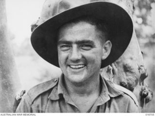 1944-03-22. NEW GUINEA. L/CPL. A.C. PEARSON (BUSTER) OF AN A.I.F. UNIT WHO ASSISTED IN MAKING THE DOCUMENTARY FILM "JUNGLE PATROL" PHOTOGRAPHED IN THE RAMU VALLEY AND FINISTERRE RANGE