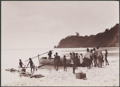 Crowd surrounding boat on a beach at Lamalana, Raga, New Hebrides, 1906 / J.W. Beattie