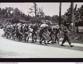 BOUGAINVILLE, 1945-09/ JAPANESE POWs BEING MARCHED TO POW COMPUNDS AT TOROKINA. BY 1945-10-12, THERE WERE 8,421 POWs ASSEMBLED AROUND TOROKINA. (DONOR - J.B. HUDSPETH)