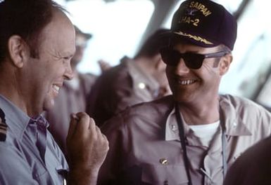 LCDR Miguel Fernandez, liaison officer for Spanish Destroyer Squadron 21, and CAPT J. W. Renard, commanding officer of the amphibious assault ship USS SAIPAN (LHA-2) talk together aboard the SAIPAN. The SAIPAN is taking part in exercise Ocean Venture '81, a joint U.S. and Spanish naval exercise