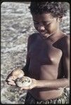 Fishing: girl holds a small puffer fish near Wawela village