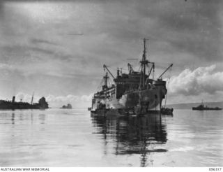 SIMPSON HARBOUR, RABAUL, NEW BRITAIN. 1945-09-10. LANDING BARGE LEAVING HMAS MANOORA TO FALL INTO FORMATION FOR THE RUN TO SHORE. THE MANOORA CARRIED TROOPS OF 4 INFANTRY BRIGADE FOR THE OCCUPATION ..