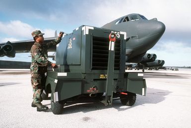 STAFF SGT. Jesse Quinata of the 43rd Field Maintenance Squadron AGE (aerospace ground equipment) branch works with an external power generator in front of B-52 Stratofortress aircraft of the 43rd Bombardment Group