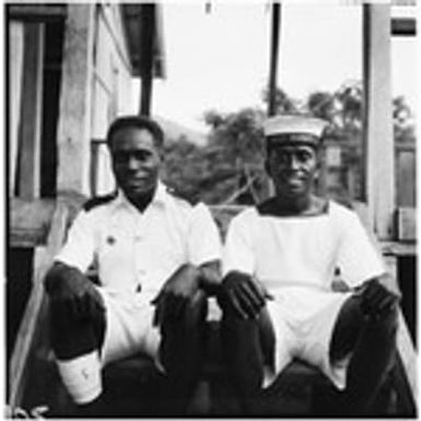 Men in uniforms on steps of building