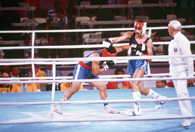 Army SPECIALIST 4 Aristides Gonzalez, right, from Fort Bragg, North Carolina, represents Puerto Rico in the boxing competition at the 1984 Summer Olympics. His opponent is Paulo Tuvale of Samoa