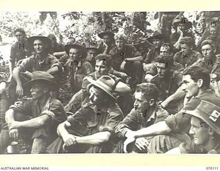 KETOBA, NEW GUINEA. 1944-01-29. THE UNIT PADRE OF THE 57/60TH INFANTRY BATTALION, HELD AN IMPROMPTU PRAYER MEETING ON THE TRAIL NEAR THE BOKU RIVER, BEFORE ATTACKING THE ORGORUNA FEATURES. ..