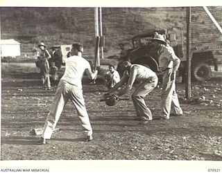 PORT MORESBY, PAPUA 1944-02. AN ACTION PHOTOGRAPH TAKEN AT A SOFTBALL MATCH BETWEEN THE UNITED STATES "OUTCASTS" TEAM AND THE AUSTRALIAN "WALLABIES". AT THIS MOMENT AN "OUTCAST" IS ABOUT TO STRIKE ..