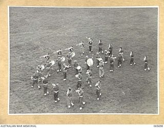 WONDECLA, QLD. 1944-04-05. BAND OF THE 2/2ND INFANTRY BATTALION PERFORMING THE COUNTER MARCH AT THE FOOT OF THE JUDGES TOWER AT THE HERBERTON RACECOURSE