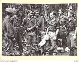 Lieutenant (Lt)  E B Russell, A Company, 42 Infantry Battalion with members of his rescuing patrol and Pilot Officer (PO) D H Trim. Identified personnel, left to right are:-  QX62989 Private (Pte) ..