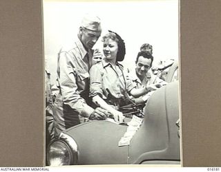 NEW GUINEA. 1943-11-22. FILM STAR GARY COOPER AND UNA MERKEL SIGN AUTOGRAPHS ON THEIR ARRIVAL AT AN AERODROME