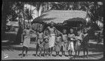 Man and boys in village; Matupit, New Britain