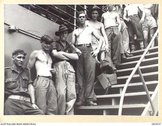 AT SEA, NEW GUINEA AREA, 1944-11-12. HEADQUARTERS 6 DIVISION TROOPS ON THE STAIRWAY LEADING TO THE AFTER WELL DECK ABOARD USS MEXICO