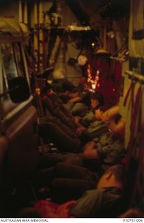 Members of 8 Troop, 17 Construction Squadron en route at night to Tonga on a 11 hour Hercules flight.  The Hercules was also carrying  two landroves in the centre of the aircraft, with no room to ..