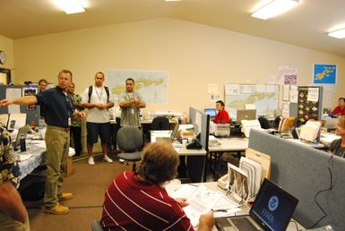 Earthquake ^ Flooding ^ Tsunami - Ottoville, American Samoa, November 30, 2009 -- The Operations Chief for the Federal Emergency Management Agency in American Samoa, Bill Roche, provides a briefing to former Chicago Bears football player, Gabe Reid (white t-shirt) and former Philadelphia Eagles football player, Reno Mahe (gray t-shirt). Reid and Mahe recently visited the island to observe the tsunami damage and to thank the workers assisting with disaster recovery. FEMA/Casey Deshong