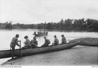 HANSA BAY-BOGIA HARBOUR, NEW GUINEA. 1944-08-09. TROOPS OF NO. 13 PLATOON, C COMPANY, 30TH INFANTRY BATTALION USING A CAPTURED JAPANESE BOAT TO CROSS THE MOUTH OF THE RAMU RIVER WHILE ON THEIR WAY ..