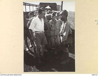 CAPE WOM, NEW GUINEA, 20-09-1945. CAPTAIN IWAMA, JAPANESE CIVILIAN INTERPRETER, SPEAKING TO LIEUTENANT-COLONEL SHIBASAKI, A SENIOR STAFF OFFICER OF 18 JAPANESE ARMY, AT HQ 6 DIVISION. CAPTAIN IWAMA ..