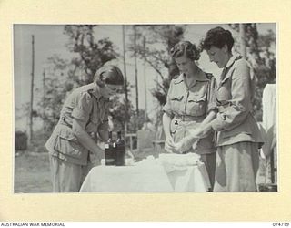 ALEXISHAFEN, NEW GUINEA. 1944-07-16. SISTERS OF THE 2/11TH AUSTRALIAN GENERAL HOSPITAL, WHO HAVE BEEN TEMPORARILY TRANSFERRED TO THE 2/15TH FIELD AMBULANCE TO HELP COPE WITH AN EPIDEMIC OF SCRUB ..