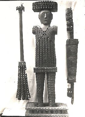 Photo of carved wooden male figure with 2 long wooden pieces (LXIII/18)
