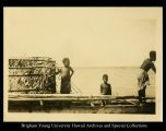 Three boys on a canoe