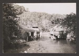 [Men Pumping Water Into Tank]