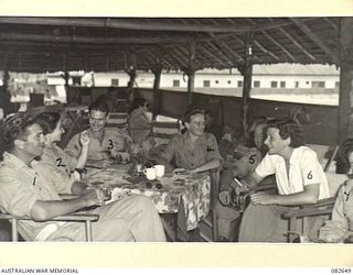 LAE AREA, NEW GUINEA. 1944-11-06. AUSTRALIAN ARMY MEDICAL WOMEN'S SERVICE AT 2/7 GENERAL HOSPITAL ENTERTAINING OTHER SERVICE PERSONNEL AT THEIR REST HUT. THIS IS PERMISSIBLE DURING MORNING AND ..
