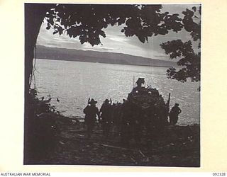 RILE, NEW BRITAIN, 1945-05-10. TROOPS OF 37/52 INFANTRY BATTALION GETTING OFF THE BARGE AT RILE DURING THEIR TREK TO MAVELU, OPEN BAY