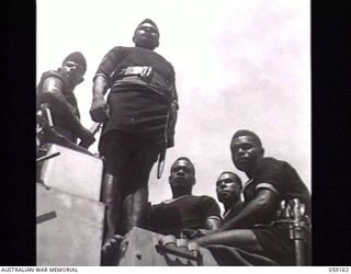 KILA, NEW GUINEA. 1943-10-24. MEMBERS OF THE ROYAL PAPUAN CONSTABULARY WHO PROVIDED THE GUARD OF HONOUR, AWAITING THE ARRIVAL OF PP1 MAJOR GENERAL B. M. MORRIS DSO, GENERAL OFFICER COMMANDING, ..